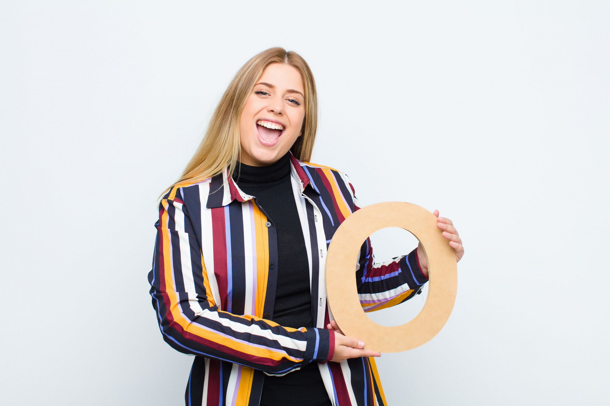 Instructor smiling with embroidery hoop in studio